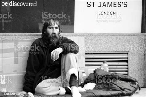 Homeless Man Sleeping On The Pavement In Central London Stock Photo