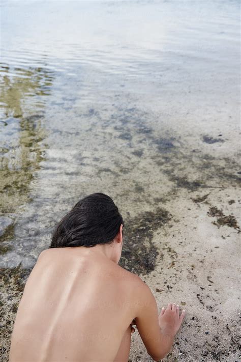 Nude Woman Exploring Ocean Lagoon By Stocksy Contributor Trinette