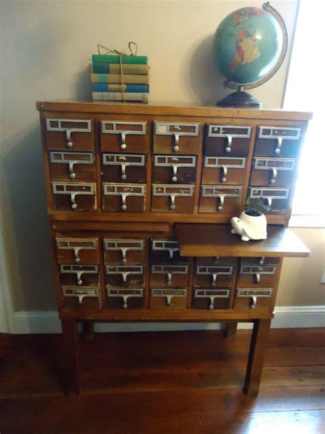 Wooden cabinet drawers with metal handle, close up. Vintage Library Card Catalog File Cabinet by ...