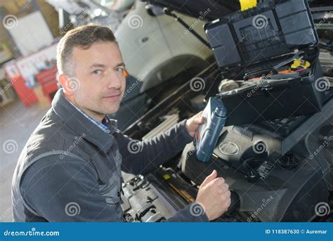 Auto Mechanic Repairman Examining Automobile Car Engine Stock Photo