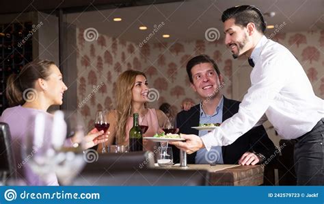 Waiter Bringing Ordered Dishes To Guests Stock Image Image Of