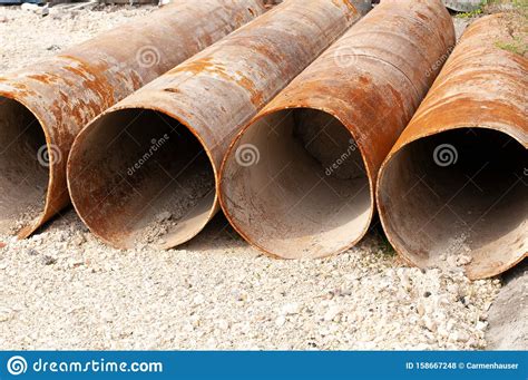 Large Rusty Iron Pipes Lying At Construction Site Stock Photo Image