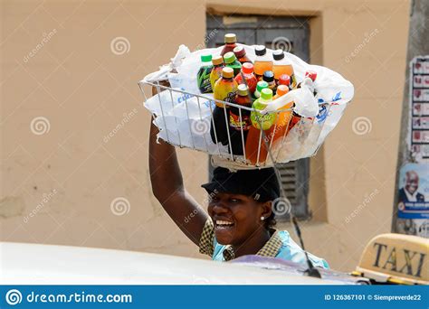 unidentified ghanaian woman carries a basket on her head at the editorial photo image of