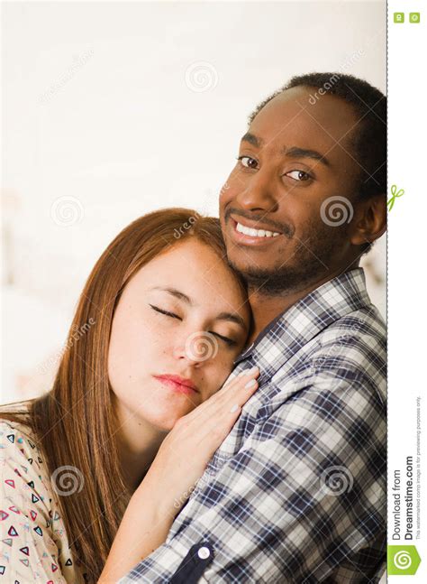 Interracial Charming Couple Wearing Casual Clothes Posing While