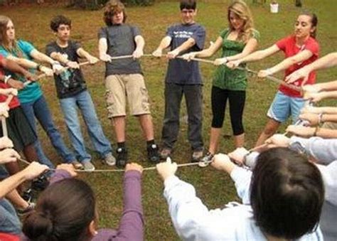 a group of people standing in a circle holding onto each other with their hands together