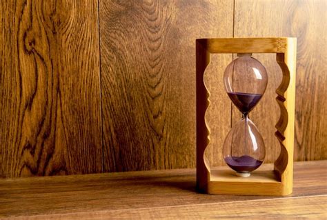 Premium Photo Glass Hourglass On The Table