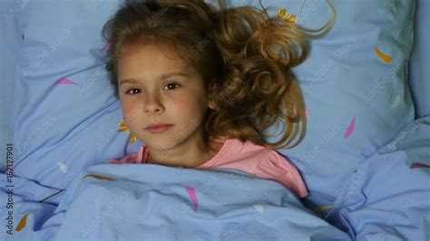 Top View Of A Sleeping Girl With Long Curly Hair A Girl Wakes Up