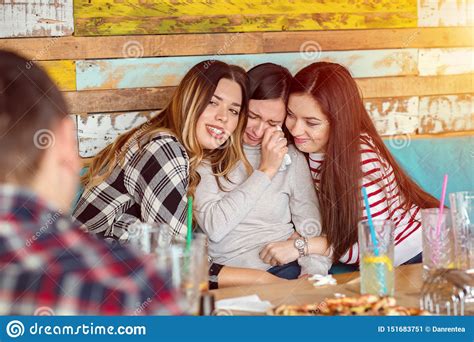 Friends Comforting And Consoling Crying Young Woman Trying To Make Her Laugh Friendship Concept