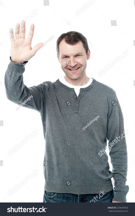 Smiling Man Standing And Waving His Hand Stock Photo 203636932