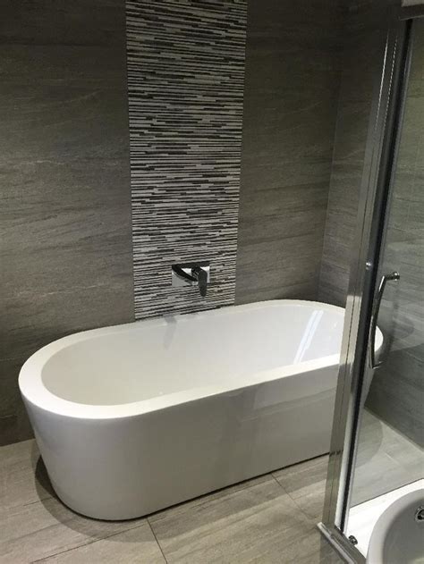 Explore neutral interior wall and floor designs. Orchard Wharfe freestanding bath | Grey bathroom tiles ...