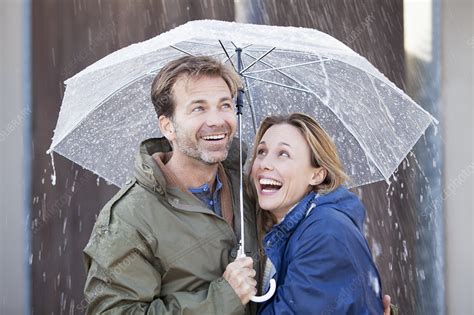Happy Couple Under Umbrella In Downpour Stock Image F0134794