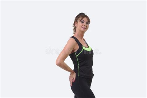 Attractive Middle Aged Woman Posing In Sports Gear And Smiling Stock
