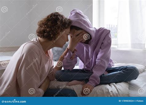 Worried Mom Comforting Depressed Teen Daughter Crying At Home Royalty Free Stock Image