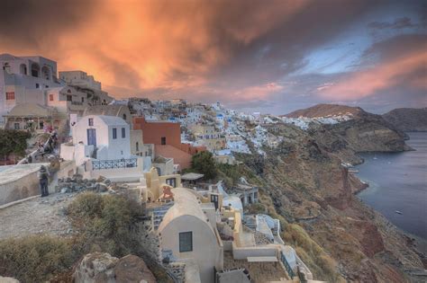 Sunset With Colorful Lite Clouds Over The Town Oia Santorini Greece