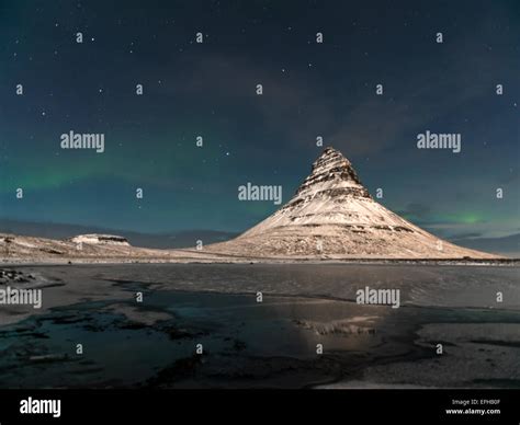Icelandic Scene Depicting Kirkjufell And The Stars In The Northern