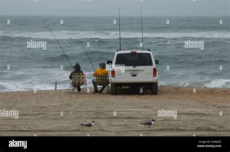 People Surf Fishing From Lee Of Car Cape Hatteras National Seashore
