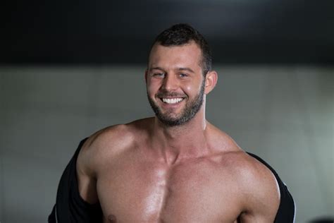 premium photo portrait of a physically fit man showing his well trained body in gym