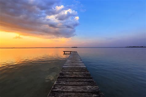 Old Wooden Jetty Pier Reveals Views Of The Beautiful Lake Blue Sky With