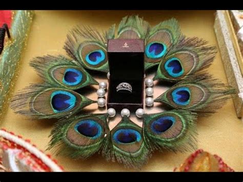 Now, place two small 'laddoos' in the pot along with engagement rings in the holder. engagement ring plates - YouTube