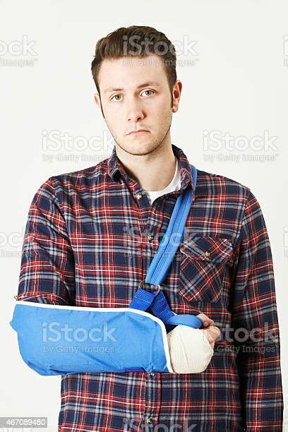 Portrait Of Young Man With Arm In Sling Stock Photo Download Image