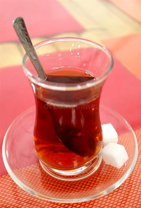 Hot Turkish Tea In Tulip Shaped Glass With Sugar Cubes On Colorful