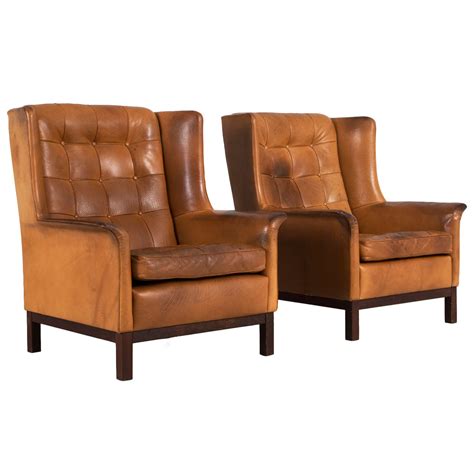Great savings & free delivery / collection on many items. Arne Norell Set of Two Highback Lounge Chairs in Cognac ...