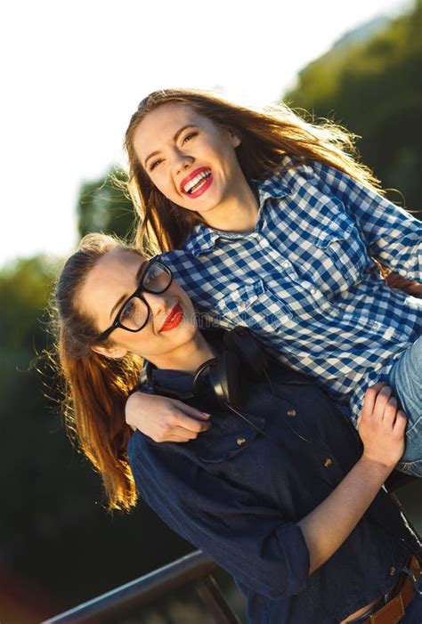 Two Playful Young Women Having Fun Outdoors Stock Image Image Of