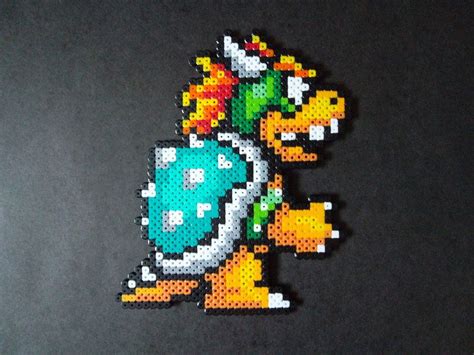 An Image Of A Pixelated Pokemon Brooch On A Black Background With Space