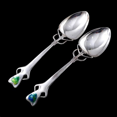 A boxed pair of rare, large, Liberty silver spoons by Oliver Baker | BADA