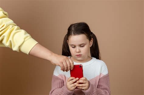 Premium Photo Portrait Of Parent Taking Smartphone Away From Girls