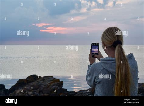 Landscape Photo Of A Woman Or Person Photographing Ocean Or Sea At