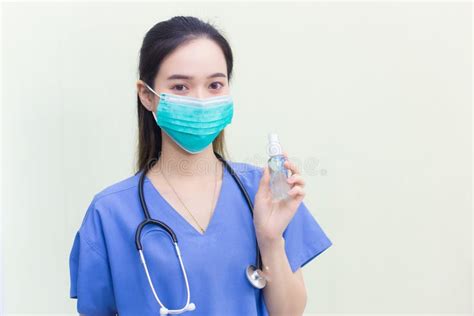 Asian Female Doctor Wearing Blue Uniform Wearing A Medical Mask