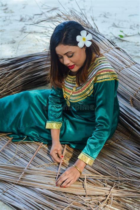 Beautiful Maldivian Woman In National Dress Making Plates For Roof