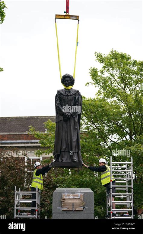 a statue of baroness margaret thatcher is lowered into place in her home town of grantham