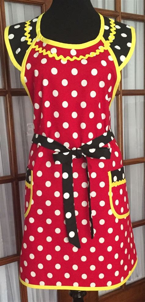 a red and white polka dot apron on a mannequin