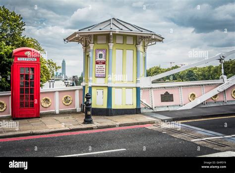 A Red London Telephone Kiosk And Tollbooth On Albert Bridge Chelsea