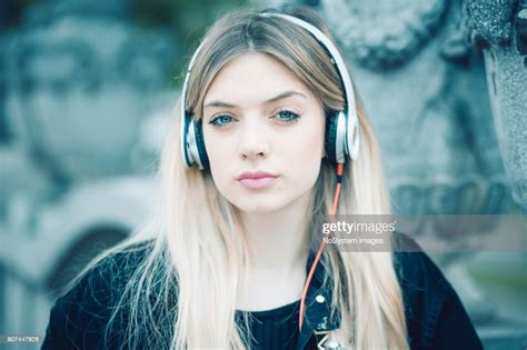 Cute Blonde Blue Eyed Teenager Girl Listening Music Outdoors High Res