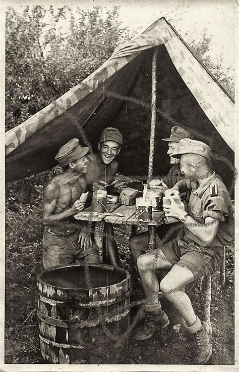 An Old Black And White Photo Of Three Men Sitting At A Table In Front