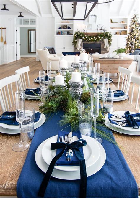 The Table Is Set With Blue And White Place Settings Silverware Pine