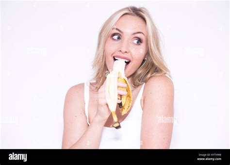 Pretty Blonde Woman Eating A Banana Stock Photo Alamy