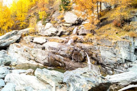 Water Cascading Over Rocks Waterfall And Autumn Colors In The