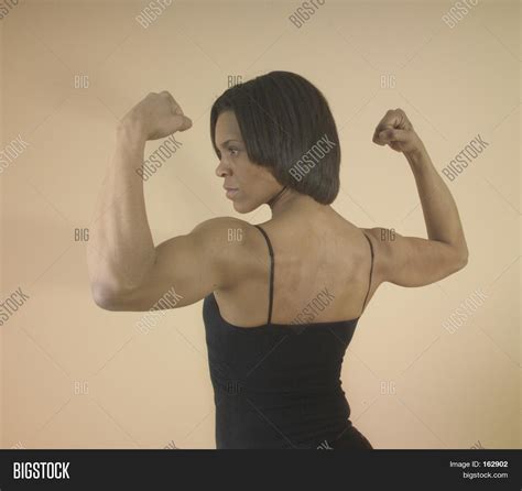 Strong Woman Flexing Her Arm Muscles Stock Photo And Stock