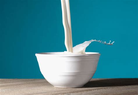 Pouring Milk Into Bowl Stock Photos Pictures And Royalty Free Images