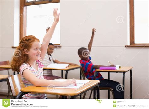 Pupils Raising Their Hands During Class Stock Photo