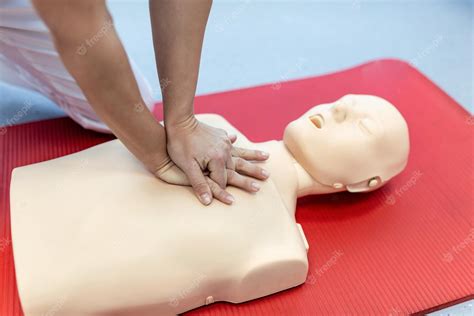 premium photo cpr training medical procedure demonstrating chest compressions on cpr doll in