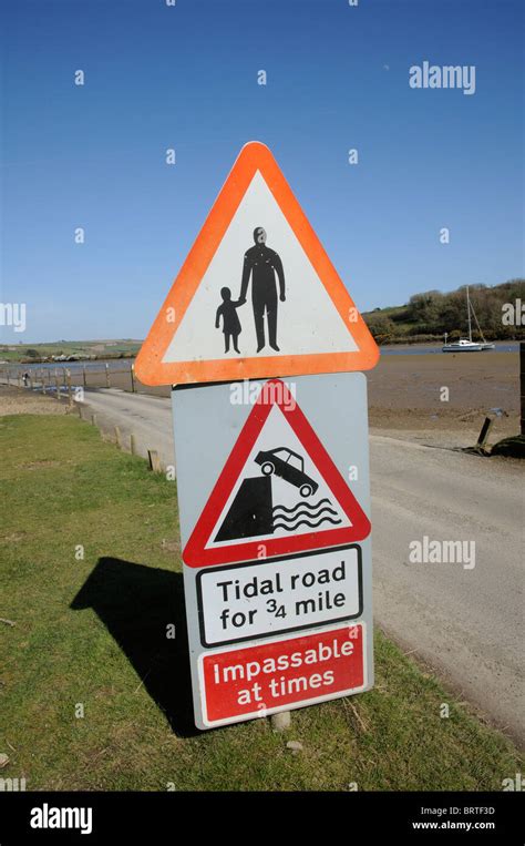 Tidal Road And Warning Signs Alongside The River Avon Between Bigbury
