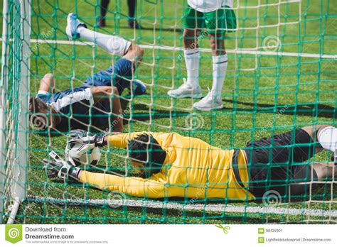 Goalkeeper Catching Ball During Soccer Game On Pitch Stock Image