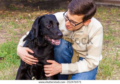 Young Man Hugging Black Labrador Park Stock Photo Edit Now 352476971