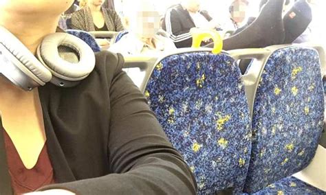 commuter shames a clinically shameless man for putting feet up on the back of seat on packed train