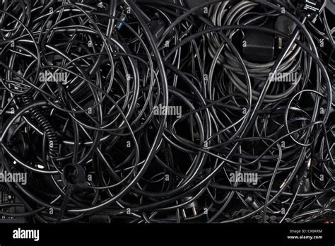 A Mess Of Tangled Black Cords And Cables Stock Photo Alamy